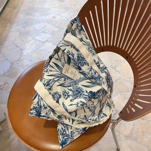 Detailed close-up of retro floral canvas tote bag on vintage chair with art label