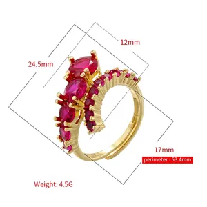 Adjustable golden hip hop ring with red prong-set oval stones and pavé accents