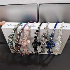 Close-up of handmade crystal headbands with floral rhinestones in seven various colors