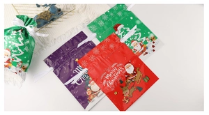 Detailed view of colorful Christmas drawstring gift bags with Santa and reindeer motifs
