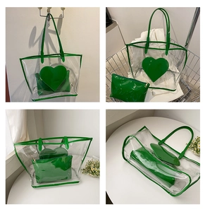 Detailed view of clear PVC tote bag with green heart-shaped pouch and small clutch bag