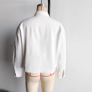 Back view detail of a white denim jacket showing the high-quality twill texture and stitching