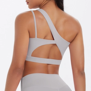 Detailed back view of light gray yoga sports bra with asymmetrical strap and cutout