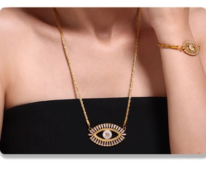 Detailed view of gold evil eye jewelry set with necklaces and bracelets on model