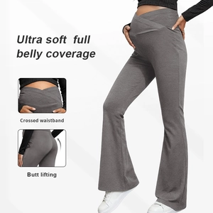 Detail of high-waisted crossover maternity yoga pants with flare leg in dark grey