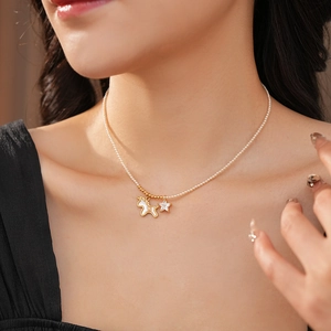 Macro detail of gold unicorn and star pendant on elegant pearl choker necklace
