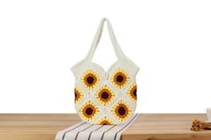 Close-up of handmade sunflower crochet tote bag with detailed knit texture and yellow petals