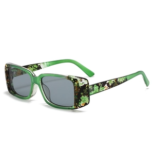 Modische Rechteck-Sonnenbrille mit grünem transparentem Rahmen und geblümten Bügeln