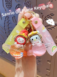 Macro detail of Sanrio My Melody and Hello Kitty aircraft liquid glitter keychains