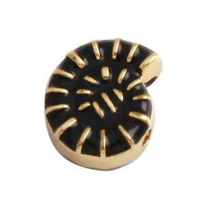 Detail view of spiral shell jewelry bead with black enamel and gold plating