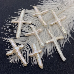 Natural white freshwater baroque pearl cross charms on elegant white feathers
