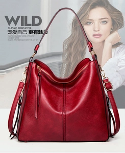 Detailed shot of retro burgundy tote bag with vintage oil wax leather texture and zipper