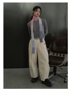 Full body model view of a long Y2K gradient striped faux mink scarf and grey knit cardigan