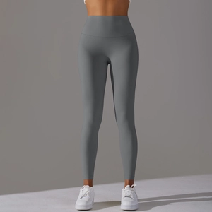 Detail view of high-waisted dark grey yoga leggings with seamless sculpting effect