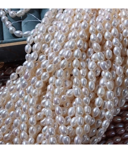 Macro shot of 5-6mm high luster natural white freshwater rice pearls for DIY jewelry