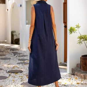 Detail of navy sleeveless maxi dress showing back pleat and refined collar tailoring