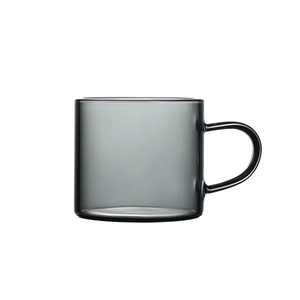 Sleek dark grey borosilicate glass teacup with handle in a minimalist style