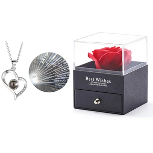 Close-up of heart necklace with I love you projection and red rose jewelry gift box