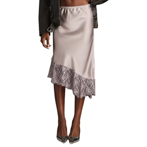 Detail of champagne satin skirt featuring asymmetrical lace trim and delicate stitching