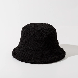 Close-up of black fuzzy bucket hat showcasing the thick texture of faux lamb wool fabric