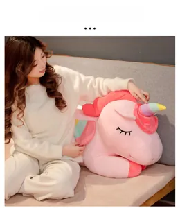 Detailed close-up of a pink unicorn plush toy with rainbow horn and soft embroidery
