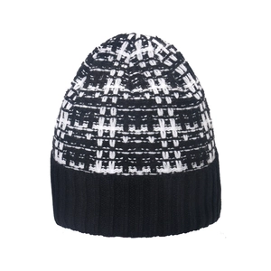 Winter checkered knit beanie in black and white plaid pattern with ribbed cuff for warmth