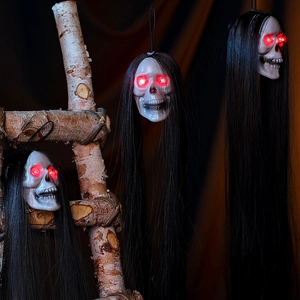 Three glowing Halloween skull ghosts with long black hair and red LED eyes for haunted house decor