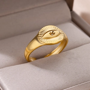 Macro detail of 18k gold plated stainless steel ring with embossed eye pattern in box
