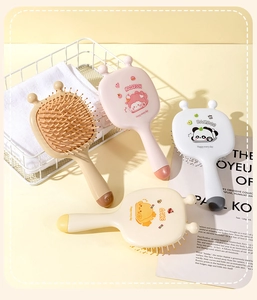 Detail of wooden bristles on cartoon animal hairbrushes with cute lamb and panda designs