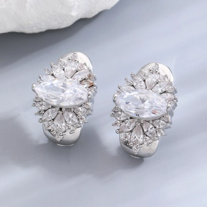 Detailed view of silver marquise-cut zircon flower drop earrings on a grey background