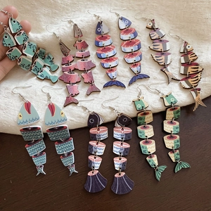 Detail showing various sushi-style sliced fish earrings with wood-print textures