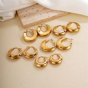 Chic gold-plated geometric hoop earrings in multiple sizes on elegant stone display