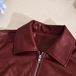 Close-up of wine red slim fit PU leather jacket featuring lapel and silver metal zipper