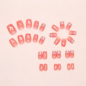 Detailed set of peach pink gradient press-on nails with butterfly and flower patterns