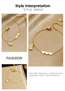 Detail of gold heart charm bracelet with pavé rhinestones on champagne silk fabric