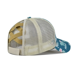Detail of cross elastic bands and messy high ponytail hole on a floral baseball cap