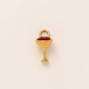 Detailed view of a golden grail pendant featuring a vibrant red gemstone inlay