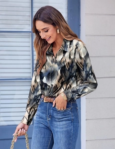Close-up of women long sleeve shirt showing marble print pattern and satin fabric texture
