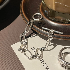 Detailed view of silver minimalist link chain bracelet with OT toggle clasp and matching ring