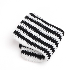 Detailed view of black and white striped knit texture on a soft woolen winter beanie