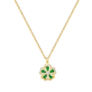 Elegant gold flower necklace with green water-drop gems and sparkling crystals on white
