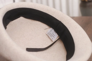 Close-up of the internal label showing 100% wool composition and adjustable sweatband