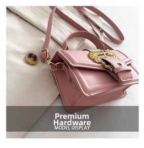 Detail of pink PU leather handbag featuring fine stitching and golden hollow metal buckle