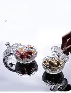 Close-up of glass candy jars with diamond-cut patterns and spherical lids for desk decor