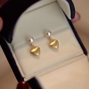Brushed gold heart earrings with freshwater pearls presented in a premium jewelry box