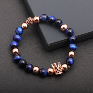 Detail of luxury tiger eye beaded bracelet with rose gold crown and black zircon micro-inlay