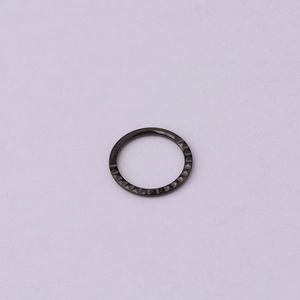 Close-up of black 316 stainless steel clicker ring with a textured diamond pattern surface