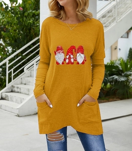 Detail showing ginger yellow long sleeve top with Santa Claus print and knit texture