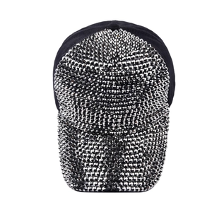 Detailed view of black baseball cap featuring dense silver cone spikes on brim and crown