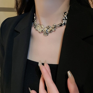 Irregular liquid metal silver necklace on model wearing a professional black suit